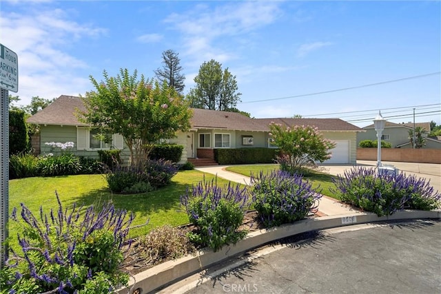 9508 Jellico Ave, Northridge, CA 91325 - view of front of house featuring an attached garage, concrete driveway, and a front lawn