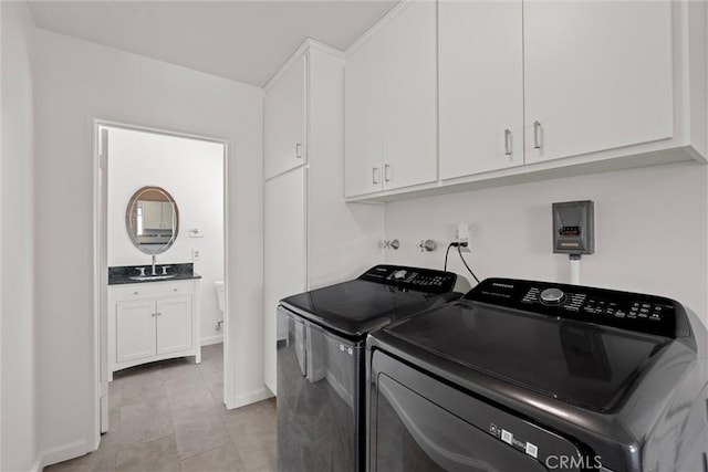 9508 Jellico Ave, Northridge, CA 91325 - laundry area with washer and clothes dryer, cabinet space, and light tile patterned floors