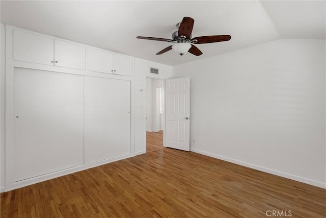 9508 Jellico Ave, Northridge, CA 91325 - unfurnished bedroom with wood finished floors, a closet, lofted ceiling, and a ceiling fan