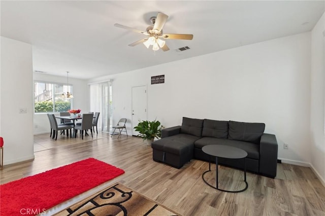 5529 N Valdez, Fresno, CA 93722 - living area with wood finished floors, a ceiling fan, and a chandelier