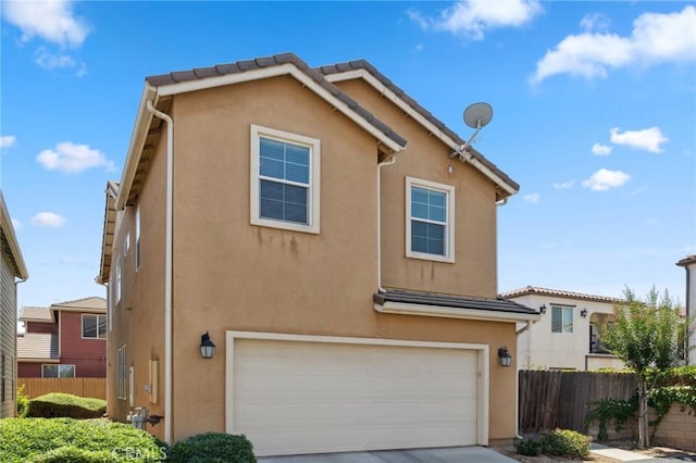 5529 N Valdez, Fresno, CA 93722 - view of front of home featuring a garage, stucco siding, and concrete driveway