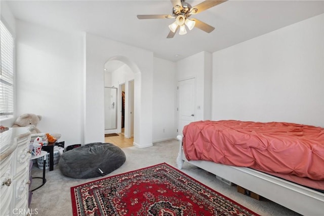 5529 N Valdez, Fresno, CA 93722 - bedroom with light colored carpet, arched walkways, and ceiling fan