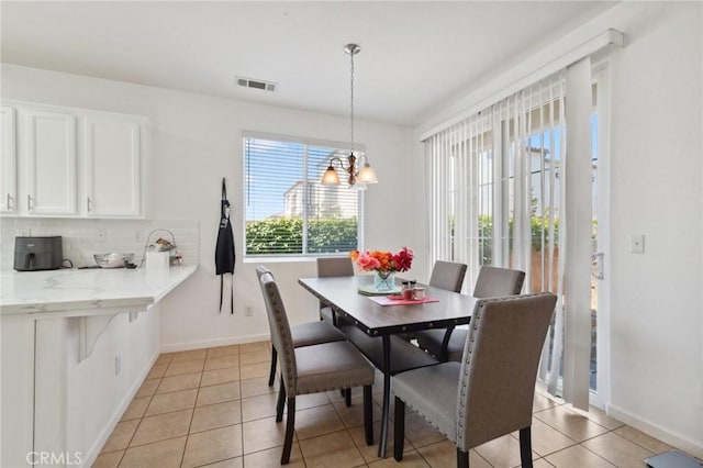 5529 N Valdez, Fresno, CA 93722 - dining room with light tile patterned flooring and a chandelier