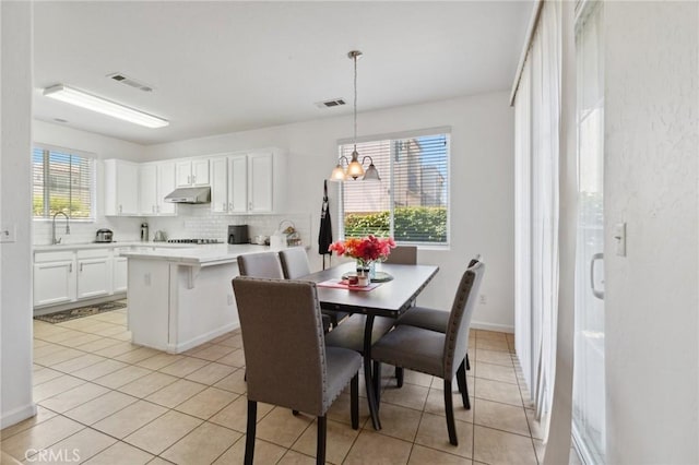 5529 N Valdez, Fresno, CA 93722 - dining room featuring light tile patterned floors and a chandelier