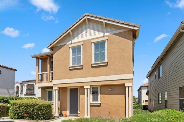 5529 N Valdez, Fresno, CA 93722 - view of front of property with stucco siding, a balcony, and a tile roof