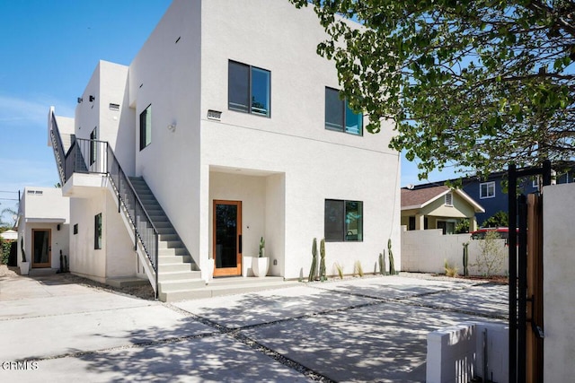 29111/2 N Coolidge Ave, Los Angeles, CA 90039 - view of front of property with stucco siding, stairway, and a patio