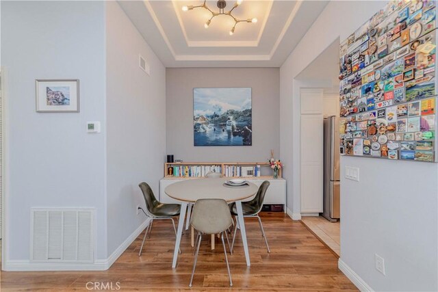 500 Tropea Aisle, Irvine, CA 92606 - dining area with a chandelier, wood finished floors, and a raised ceiling