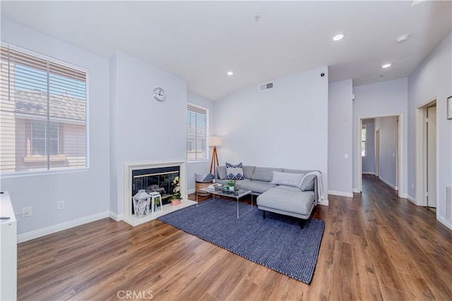 500 Tropea Aisle, Irvine, CA 92606 - living room with wood finished floors, plenty of natural light, a glass covered fireplace, and recessed lighting