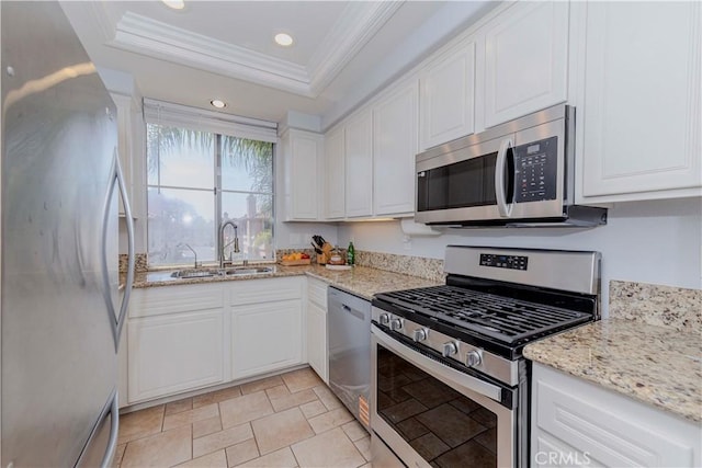 500 Tropea Aisle, Irvine, CA 92606 - kitchen with stainless steel appliances, crown molding, white cabinetry, a tray ceiling, and light stone countertops