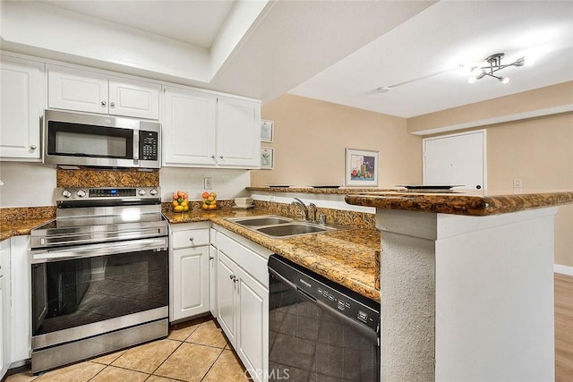 64 N Mar Vista Ave Unit 231, Pasadena, CA 91106 - kitchen featuring stainless steel appliances, a peninsula, white cabinets, and light tile patterned flooring