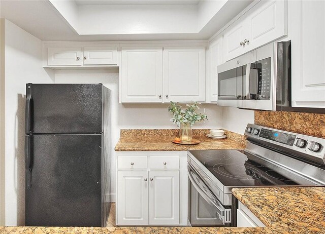 64 N Mar Vista Ave Unit 231, Pasadena, CA 91106 - kitchen featuring appliances with stainless steel finishes, white cabinetry, light countertops, and a raised ceiling