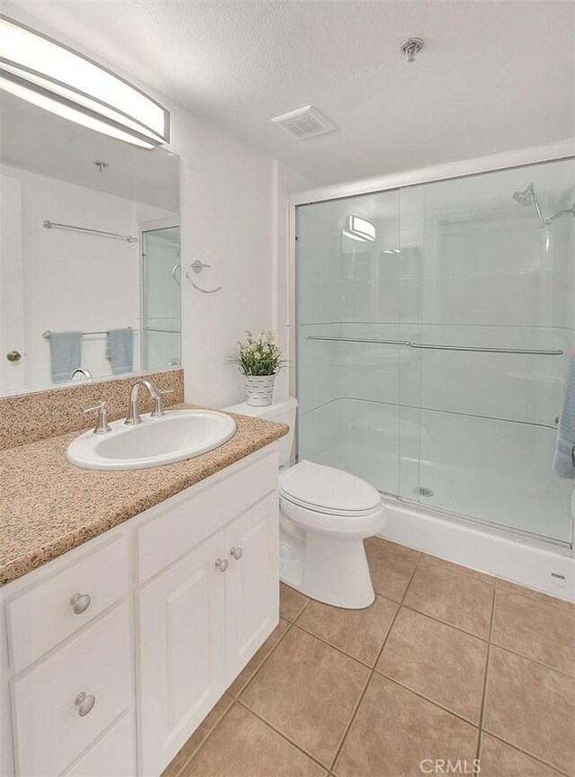 64 N Mar Vista Ave Unit 231, Pasadena, CA 91106 - full bath with vanity, tile patterned flooring, a shower stall, and a textured ceiling