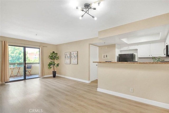 64 N Mar Vista Ave Unit 231, Pasadena, CA 91106 - unfurnished living room featuring light wood-style floors and a chandelier