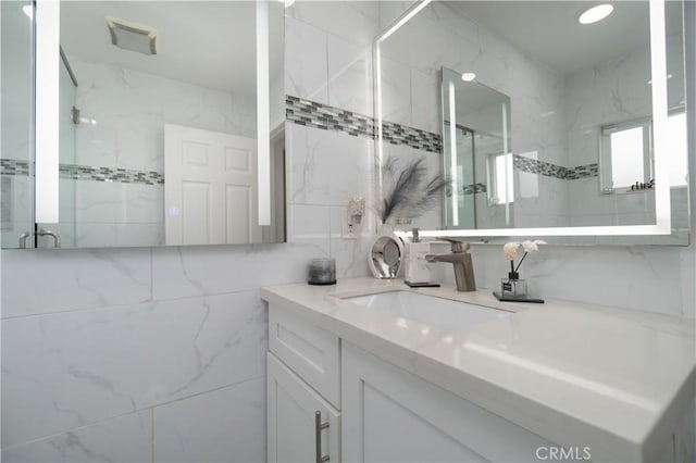 3219 E 6th St, Los Angeles, CA 90023 - full bath with vanity, a marble finish shower, and tile walls