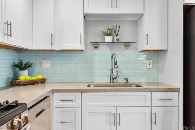3833 Tomahawk Ln, San Diego, CA 92117 - kitchen featuring white cabinets, decorative backsplash, open shelves, and light stone counters
