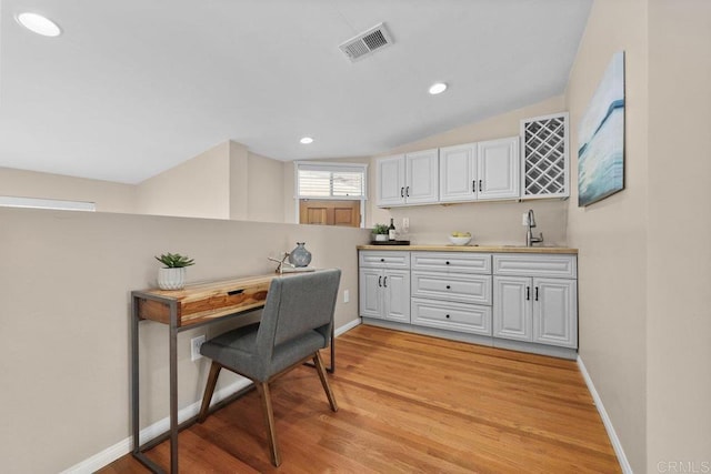 3833 Tomahawk Ln, San Diego, CA 92117 - office featuring light wood-style floors, bar with sink, vaulted ceiling, and recessed lighting