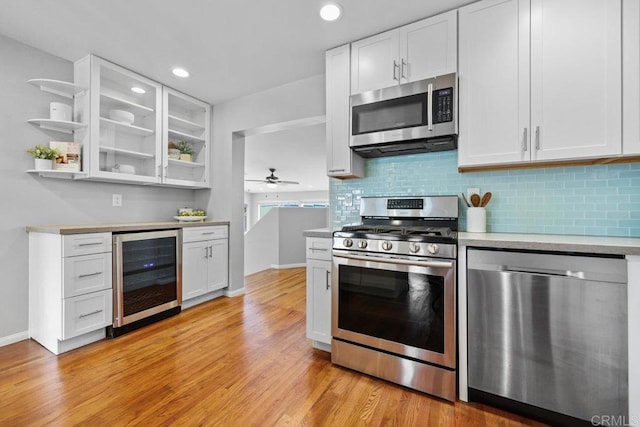 3833 Tomahawk Ln, San Diego, CA 92117 - kitchen featuring wine cooler, appliances with stainless steel finishes, open shelves, white cabinetry, and recessed lighting