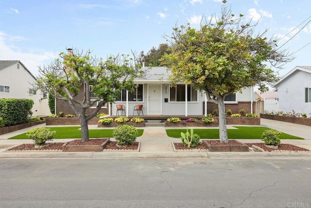 3833 Tomahawk Ln, San Diego, CA 92117 - view of front of home featuring covered porch, a front yard, and driveway