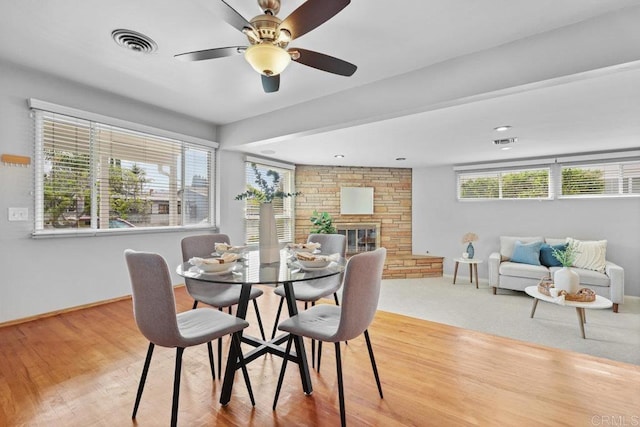 3833 Tomahawk Ln, San Diego, CA 92117 - dining room with a fireplace, light wood-type flooring, and a ceiling fan