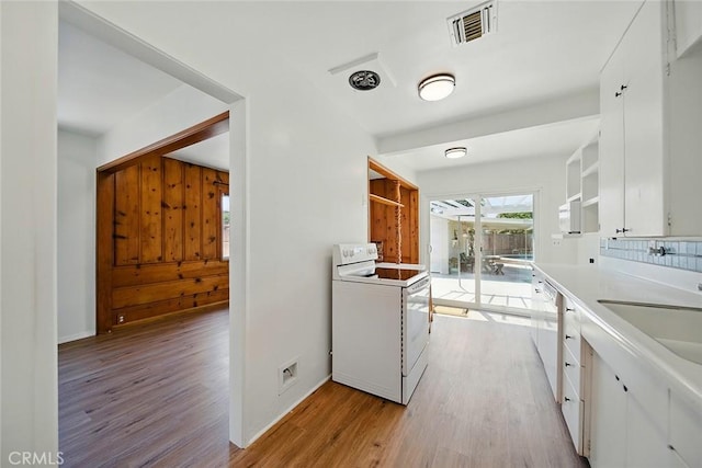 185 N Rodecker Dr, Azusa, CA 91702 - kitchen with white appliances, open shelves, light wood-type flooring, white cabinetry, and decorative backsplash