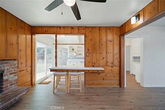 185 N Rodecker Dr, Azusa, CA 91702 - unfurnished dining area featuring a ceiling fan, wood finished floors, and wooden walls