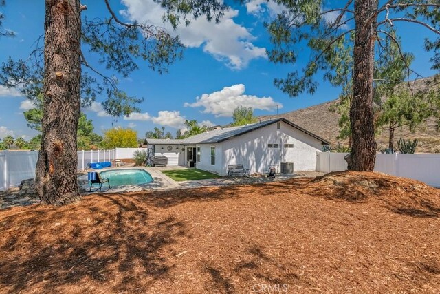 27111 Crews Hill Dr, Menifee, CA 92586 - back of house with a fenced backyard, a patio, and solar panels