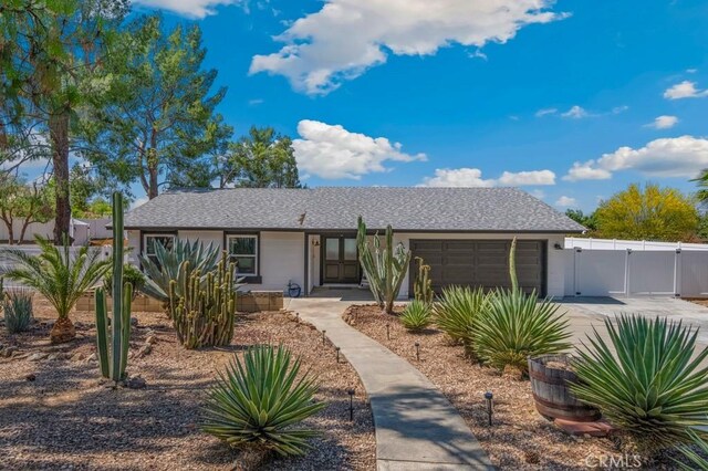 27111 Crews Hill Dr, Menifee, CA 92586 - ranch-style house featuring a garage, a gate, driveway, and stucco siding