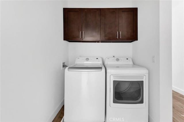 7419 N Mia Ln, Van Nuys, CA 91405 - laundry area featuring cabinet space, independent washer and dryer, and wood finished floors