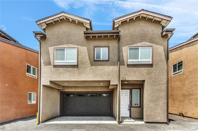 7419 N Mia Ln, Van Nuys, CA 91405 - back of house featuring stucco siding, an attached garage, and asphalt driveway