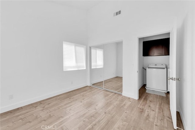7419 N Mia Ln, Van Nuys, CA 91405 - unfurnished bedroom with washer / dryer, light wood-style floors, and a closet