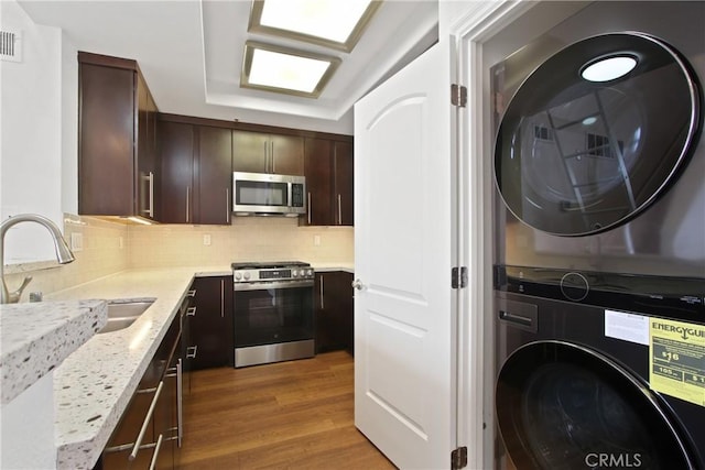 35 Linden Ave Unit 504, Long Beach, CA 90802 - washroom with stacked washer and clothes dryer and wood finished floors