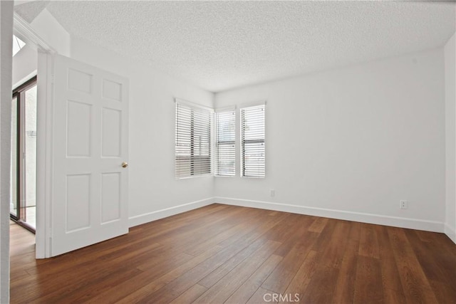 35 Linden Ave Unit 504, Long Beach, CA 90802 - unfurnished bedroom with a textured ceiling, dark wood finished floors, and multiple windows