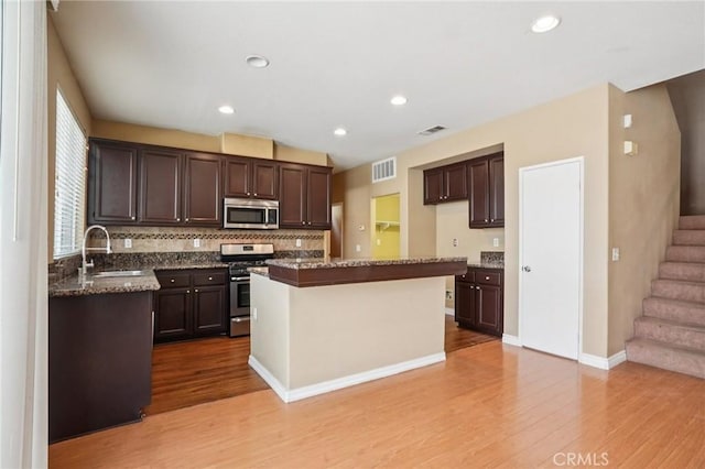 12910 Jersey St, Eastvale, CA 92880 - kitchen featuring stainless steel appliances, light wood-type flooring, dark brown cabinetry, and recessed lighting