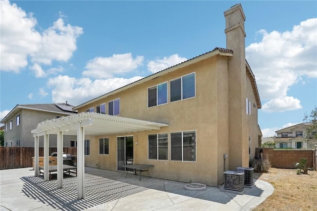 12910 Jersey St, Eastvale, CA 92880 - rear view of property featuring a pergola, a patio, stucco siding, and a chimney