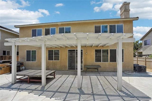 12910 Jersey St, Eastvale, CA 92880 - rear view of house with stucco siding, a pergola, a chimney, and a patio area