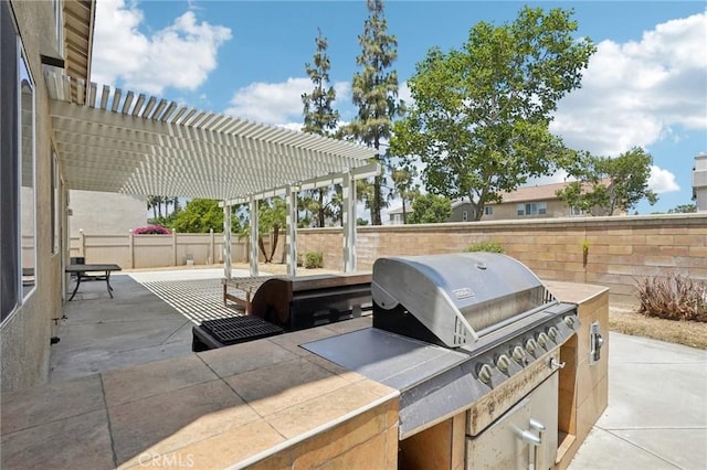 12910 Jersey St, Eastvale, CA 92880 - view of patio with a pergola and exterior kitchen