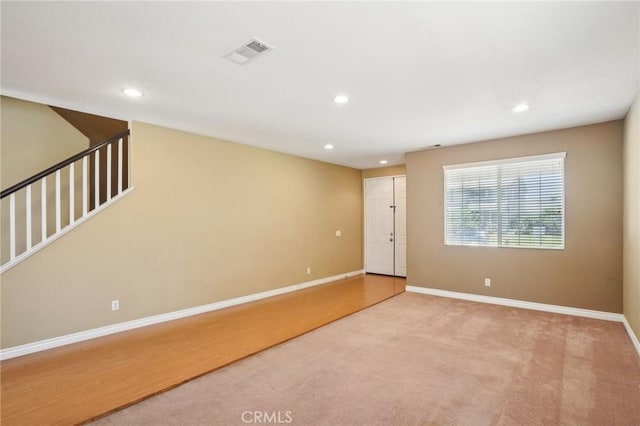 12910 Jersey St, Eastvale, CA 92880 - carpeted spare room featuring recessed lighting and stairway