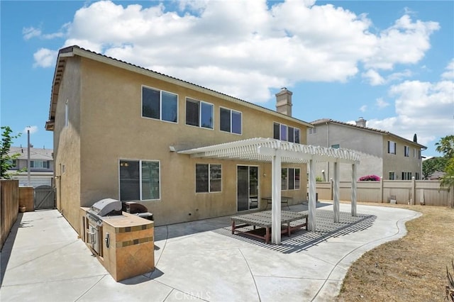 12910 Jersey St, Eastvale, CA 92880 - back of property featuring a pergola, a fenced backyard, a patio, and stucco siding