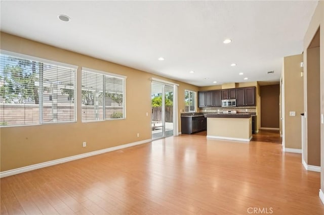 12910 Jersey St, Eastvale, CA 92880 - unfurnished living room featuring light wood-style floors and recessed lighting