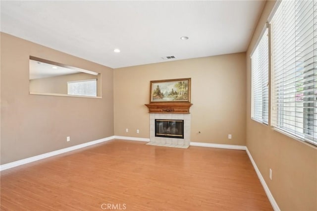 12910 Jersey St, Eastvale, CA 92880 - unfurnished living room featuring light wood finished floors, a tile fireplace, and recessed lighting