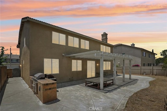 12910 Jersey St, Eastvale, CA 92880 - back of house featuring a pergola, a patio area, a fenced backyard, and stucco siding
