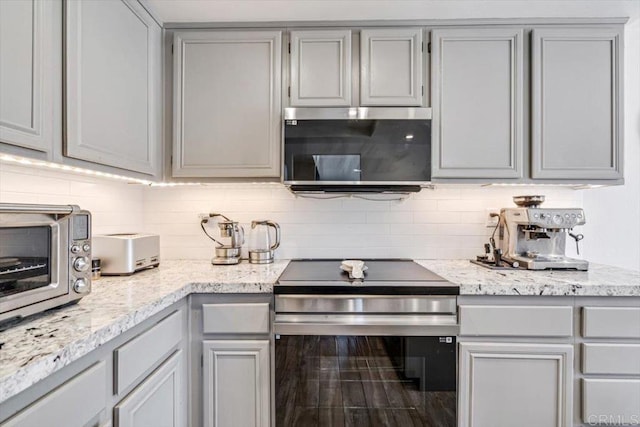 17915 Caminito Pinero Unit 264, San Diego, CA 92128 - kitchen featuring stainless steel appliances, gray cabinetry, tasteful backsplash, and light stone countertops