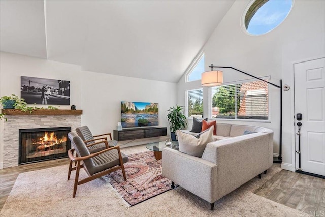 17915 Caminito Pinero Unit 264, San Diego, CA 92128 - living room featuring high vaulted ceiling, wood finished floors, and a fireplace