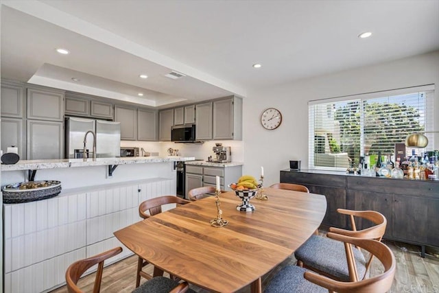 17915 Caminito Pinero Unit 264, San Diego, CA 92128 - dining room featuring light wood-style flooring, recessed lighting, and a raised ceiling