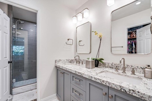 17915 Caminito Pinero Unit 264, San Diego, CA 92128 - bathroom with a stall shower, double vanity, and a spacious closet
