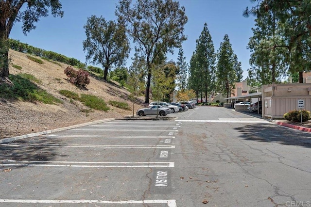 17915 Caminito Pinero Unit 264, San Diego, CA 92128 - view of asphalt road featuring curbs