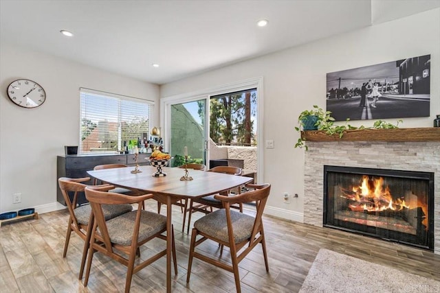 17915 Caminito Pinero Unit 264, San Diego, CA 92128 - dining room with wood finished floors, a fireplace, and recessed lighting