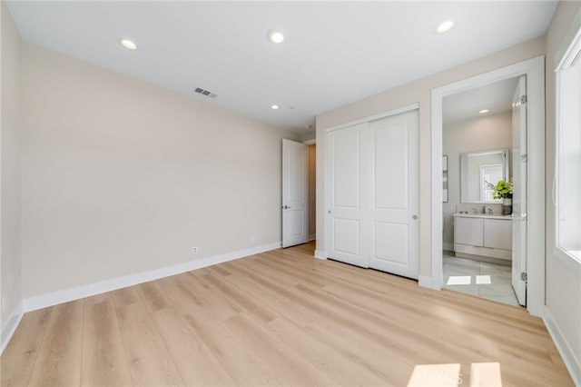 211 Wild Flower, Lake Forest, CA 92630 - unfurnished bedroom featuring light wood finished floors, connected bathroom, recessed lighting, and a closet