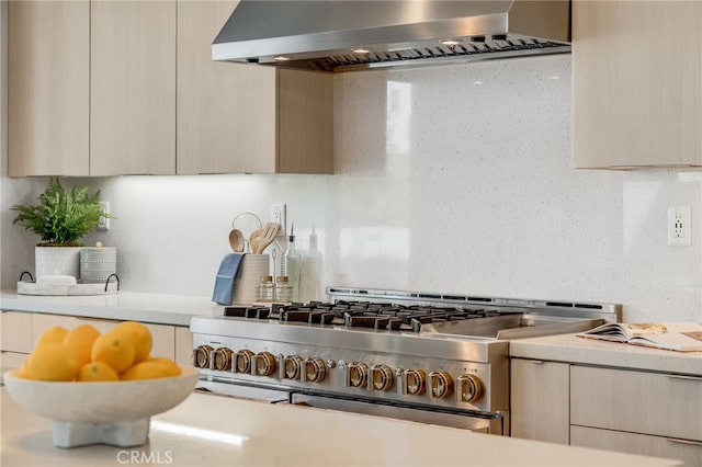 211 Wild Flower, Lake Forest, CA 92630 - kitchen featuring wall chimney range hood, stainless steel range, light countertops, modern cabinets, and light brown cabinetry