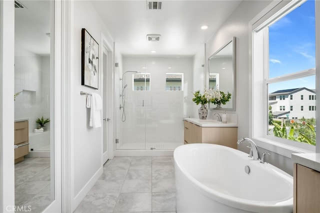 211 Wild Flower, Lake Forest, CA 92630 - bathroom featuring vanity, a shower stall, plenty of natural light, a freestanding bath, and recessed lighting